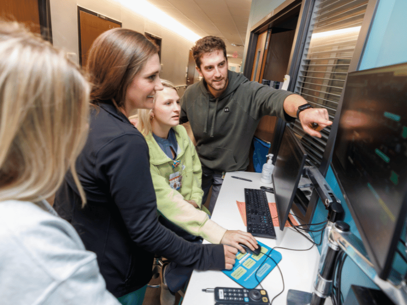 From left, accelerated bachelor of science in nursing student Julianne Deweese and registered nurses Emily Wade, Rebekah Scitzs and Ben Tarver collaborate during a PICU shift.